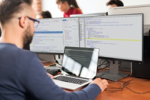 man using a lot of computers