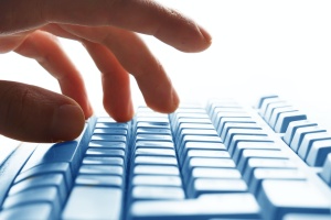 typing on computer with CMMC level 1 compliance