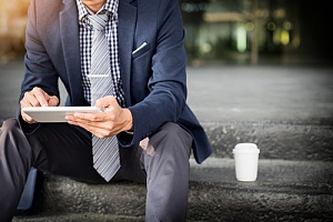 a business owner reading an eBook on his laptop