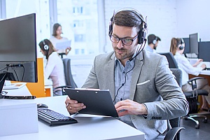 a business owner speaking with a client through virtual phone systems