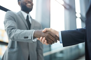 a handshake between a small business owner and a Brooklyn, NY managed IT services provider