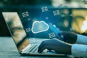 a man working on emailing on his computer backed up by the cloud