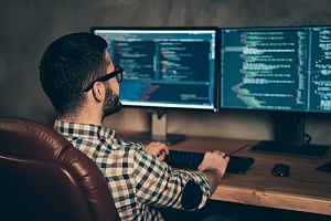 a man working on his computer doing cyber security