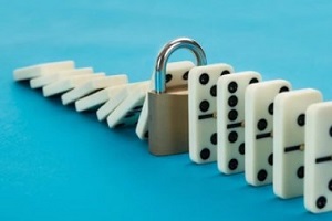 business continuity plan concept with lock and dominos