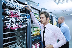 business people it engineer in network server room solving problems and give help and support