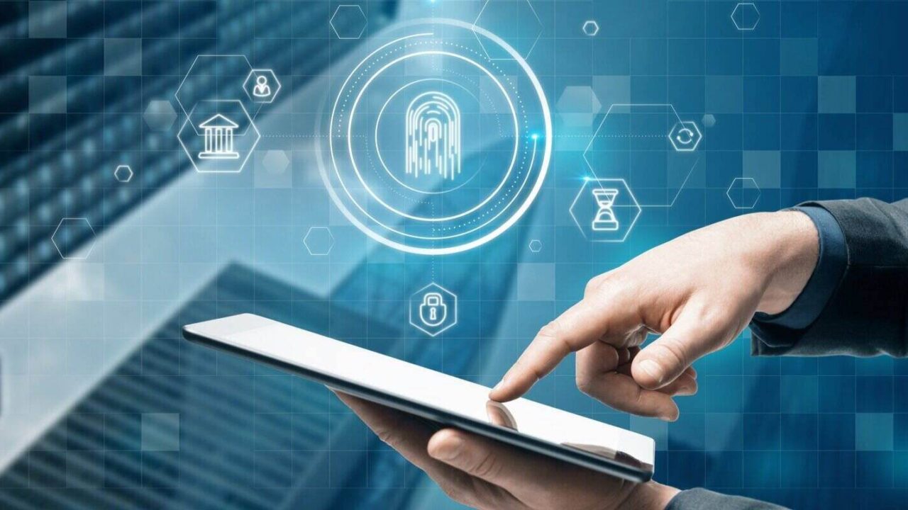 businessman hand pointing at tablet with abstract glowing id fingerprint web protection and security interface on blurry