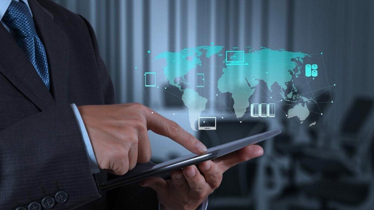 businessman hand using tablet computer and board room background