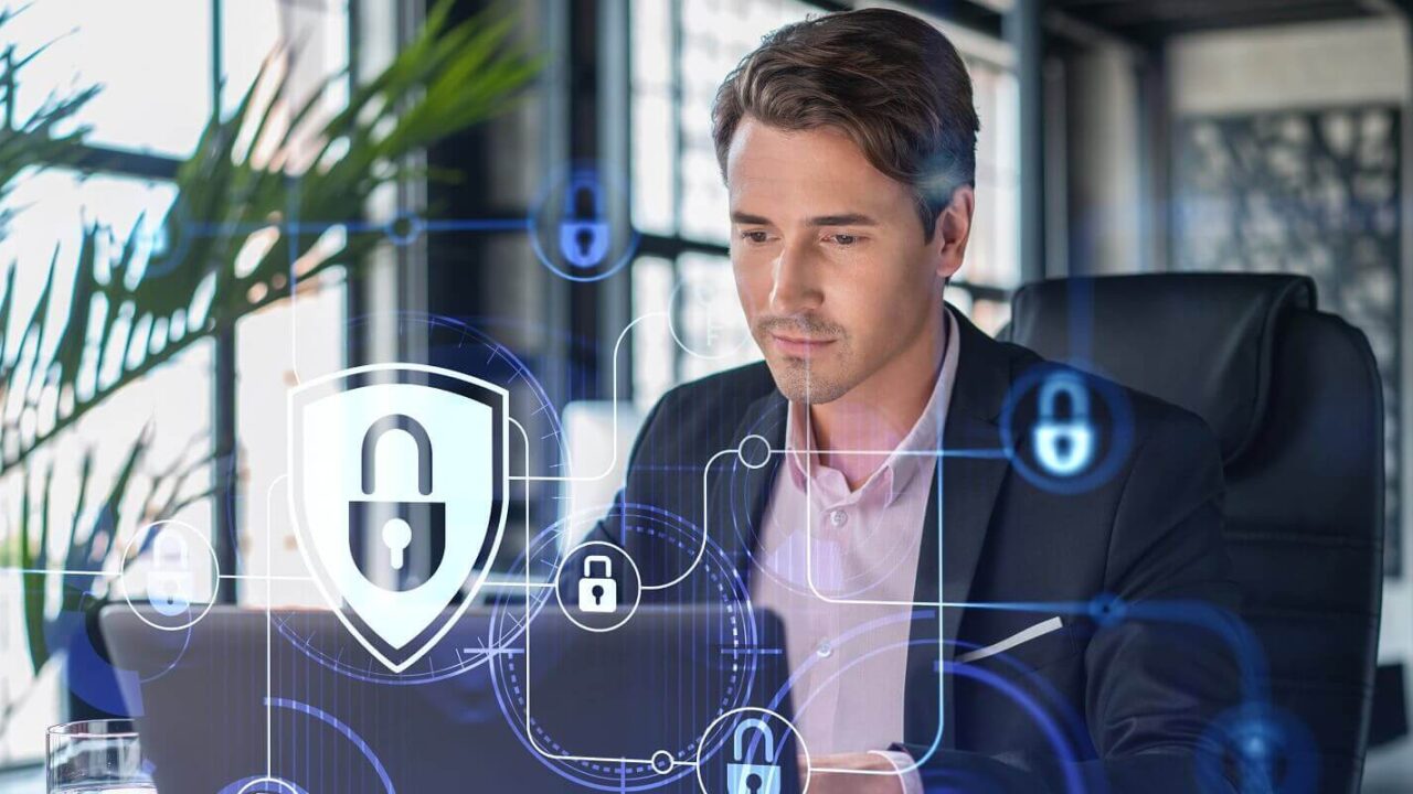 businessman in suit at workplace working with laptop to defend customer cyber security