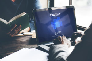 consultant of a managed IT services firm backups the clients data
