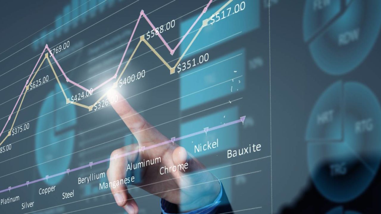consultant of a managed IT services firm points to a spot on the graph
