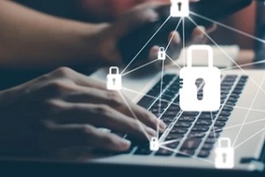 cybersecurity concept with man working on laptop in background