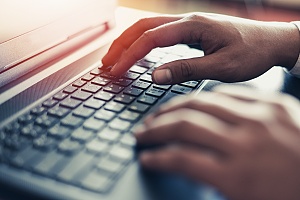 hands typing at a computer to perform it security penetration testing for a brooklyn ny business