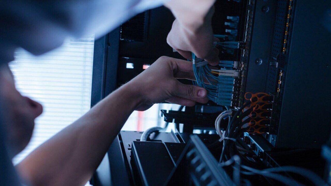 hard working experienced technician working with network cables