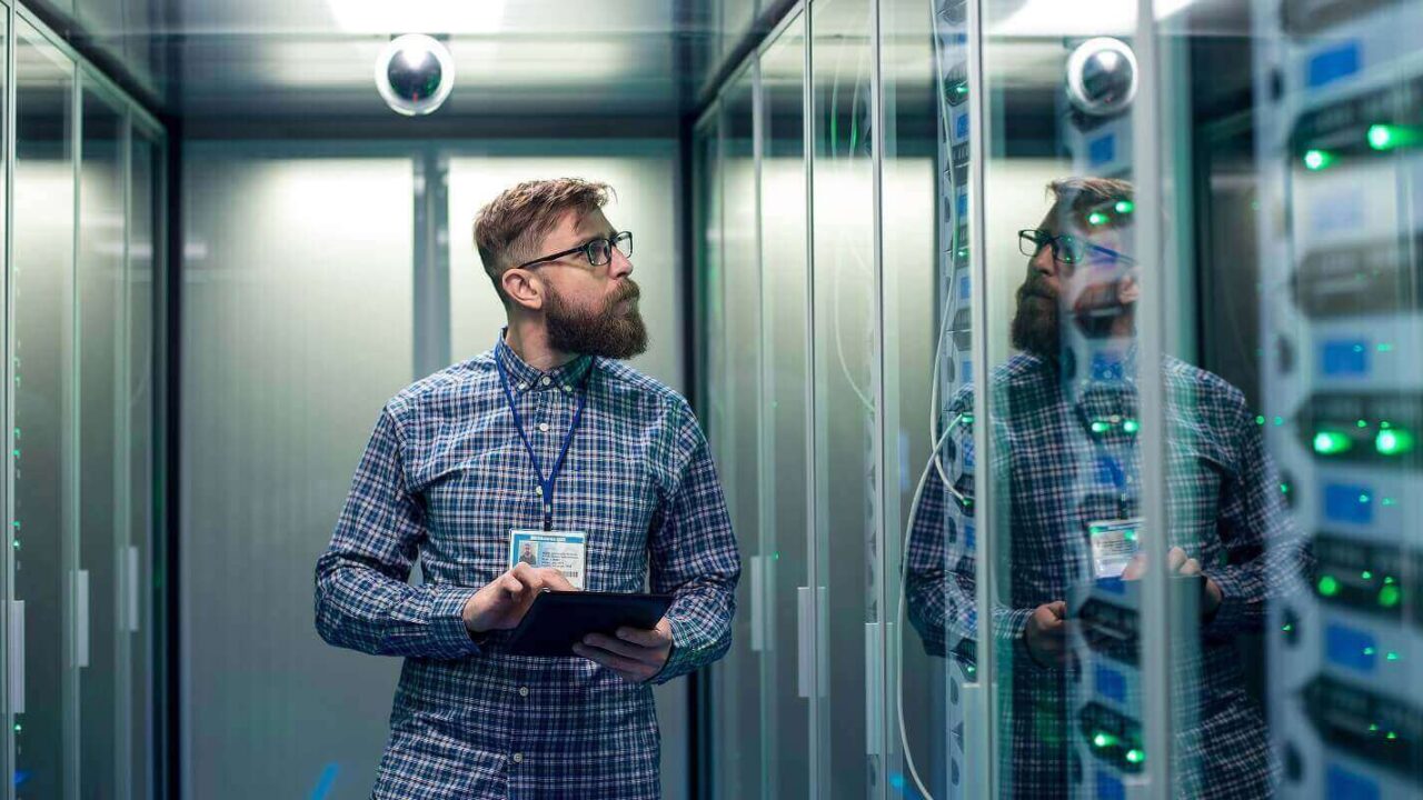 it engineer with tablet in server room