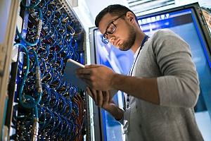 it security services worker tending to network cabling at a client office