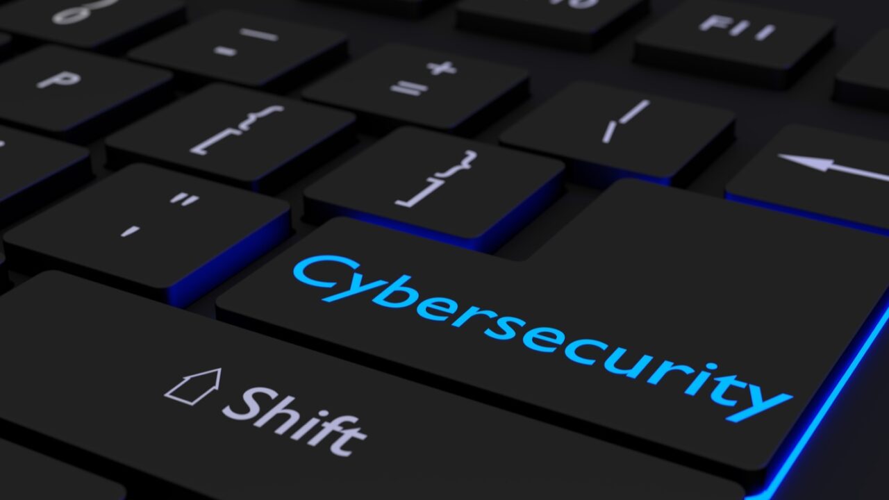 keyboard where the enter key is glowing blue showing the word cybersecurity