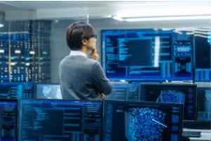 Man checking consoles and verifying the CMMC level implementation in the organization