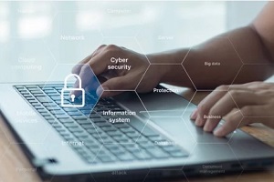 man working on laptop while cyber security on screen