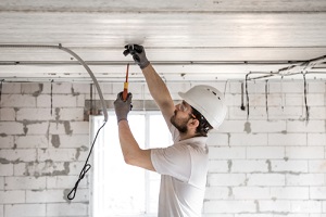 man  working with cable on the construction site