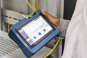 IT worker providing structured cabling support to a business with a lot of cables in new york city