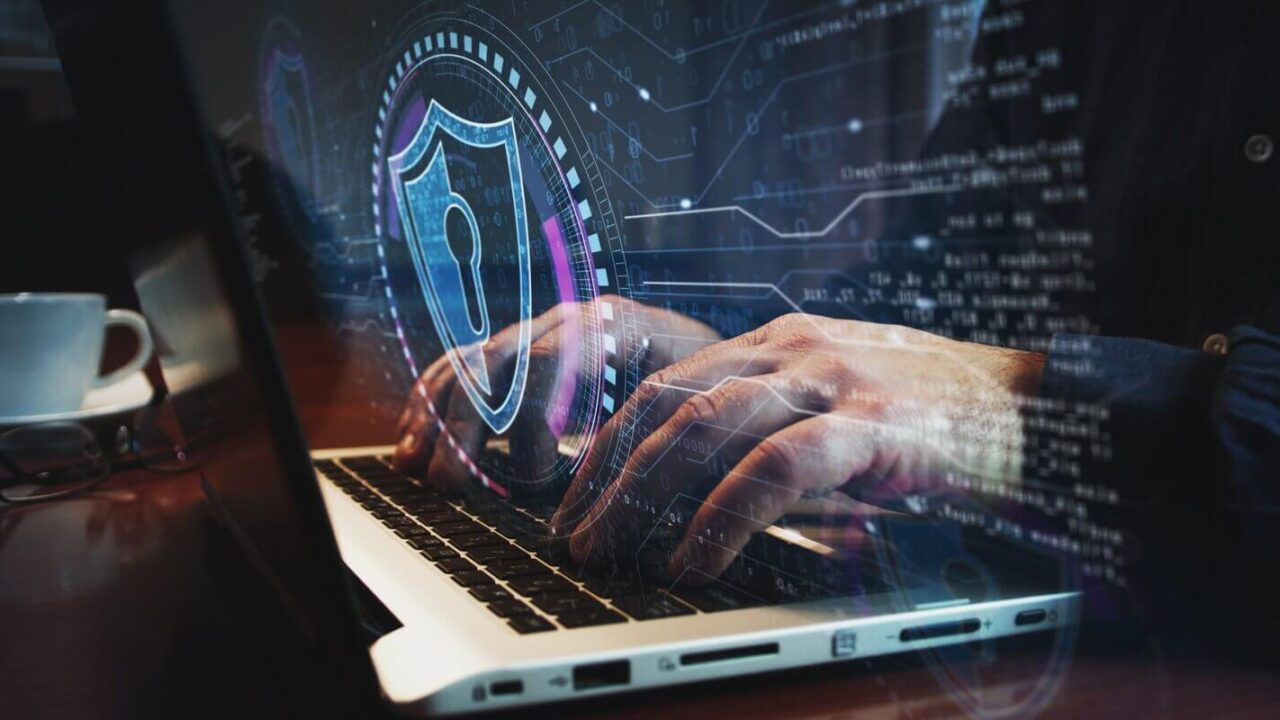 hands typing a password through a security portal on a laptop