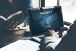 person on their laptop implementing it security measures to protect his infrastructure