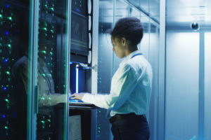 it cybersecurity consultant fixing an issue in a server room