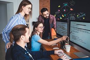 Group of employees looking at computer monitor