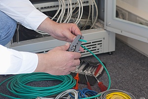 structured cable being installed by a networking specialist