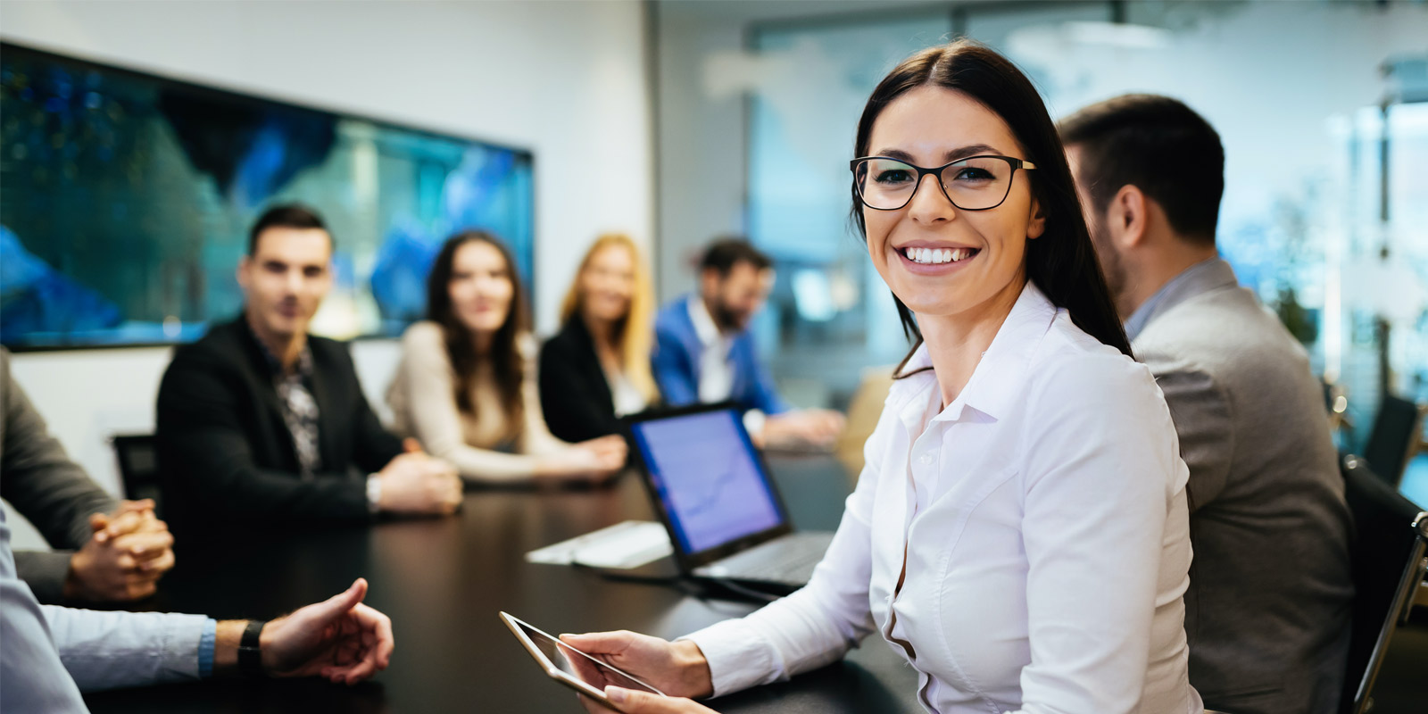 Team of employees sitting at table