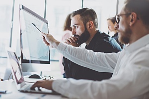 two employees analyzing a security risk report