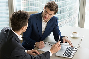 two individuals developing a disaster recovery plan for a small business