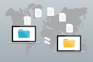 two laptops with folders on screen and transferred documents