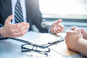 two people working on a compliance for government contracts