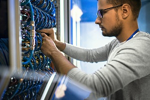 IT professional providing structured cabling services and organizing network cables at a NYC business